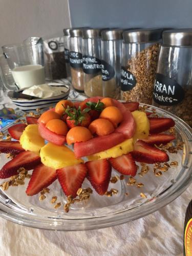 a plate of fruit on top of a table at Palm Beach Guesthouse in Port Elizabeth