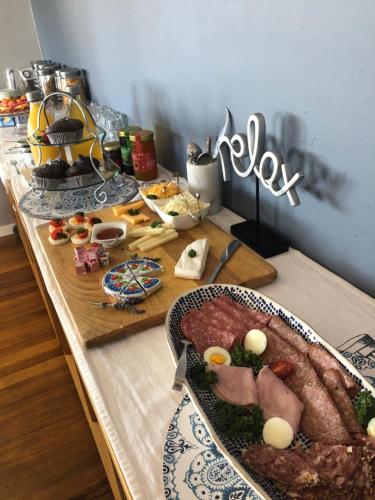 a table with plates of food on top of it at Palm Beach Guesthouse in Port Elizabeth