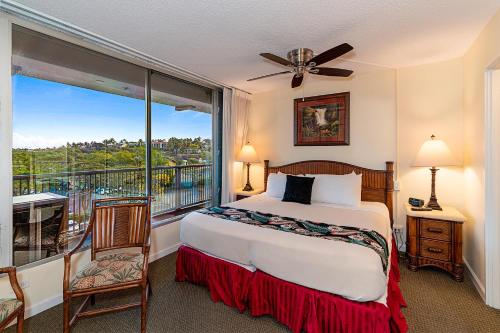 a bedroom with a bed and a balcony at Mana Kai 410 - Ocean front at Keawakapu Beach, AC in Wailea