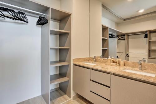 a bathroom with two sinks and two mirrors at Luxe Cabo Condo w/ Ocean Views + Amenities! in Cabo San Lucas
