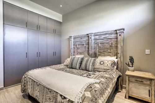 a bedroom with a bed and a wooden headboard at Luxe Cabo Condo w/ Ocean Views + Amenities! in Cabo San Lucas