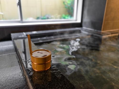 a cup of coffee sitting on top of a table at Super Hotel Okayama Station Higashiguchi in Okayama