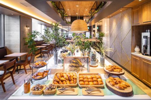 a buffet of pastries on a table in a restaurant at Super Hotel Okayama Station Higashiguchi in Okayama