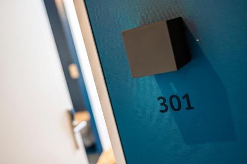 a close up of a door with a clock on it at Hotel Oltnerhof - Self Check in in Olten