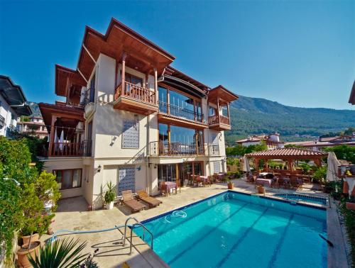 a house with a swimming pool in front of it at Gumus Konak in Akyaka