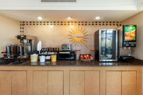 a kitchen with a counter top with a coffee machine at La Quinta Inn by Wyndham Bossier City in Bossier City