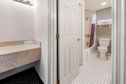 a bathroom with a toilet and a sink at La Quinta Inn by Wyndham Ft. Lauderdale Tamarac East in Fort Lauderdale
