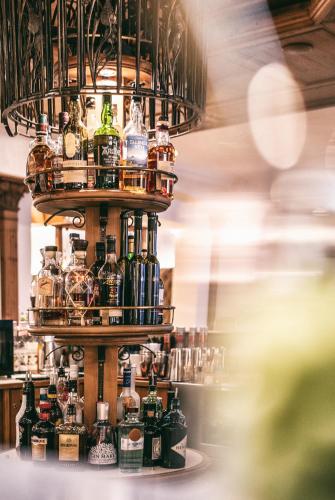 a display of bottles of alcohol on a shelf at Wellnesshotel Warther Hof in Warth am Arlberg