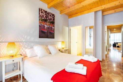 1 dormitorio con 1 cama blanca grande con manta roja en Spacious Sagrada Familia By MyRentalHost, en Barcelona