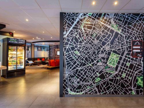 a large mural in the middle of a lobby at Ibis Brussels City Centre in Brussels