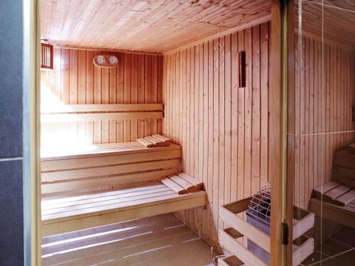 a wooden sauna with wooden benches in a room at Novotel London Waterloo in London
