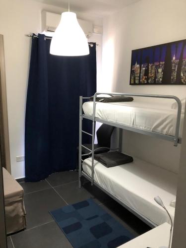 a room with two bunk beds and a lamp at 189 Chezli Court in Birżebbuġa