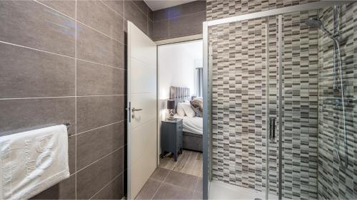 - une salle de bains pourvue d'une douche à l'italienne à côté d'une chambre dans l'établissement L'O Rouge - Apt A203 - BO Immobilier - Châtel, à Châtel