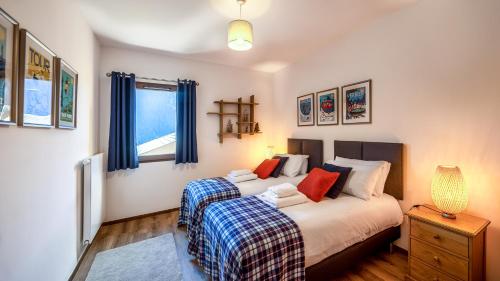 Katil atau katil-katil dalam bilik di L'O Rouge - Apt A102 - BO Immobilier- Châtel-remises sur les forfaits de skis Châtel ou Portes du soleil