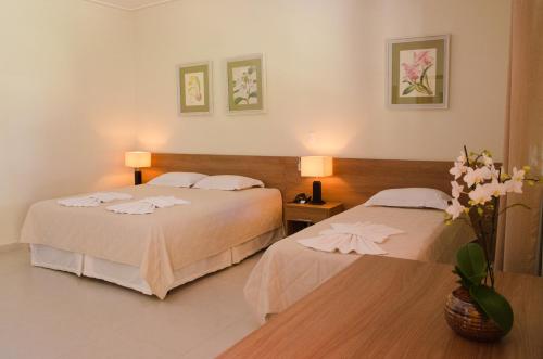 A bed or beds in a room at Villa de Holanda Parque Hotel