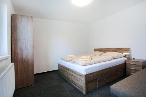 a bedroom with a bed with two towels on it at Apartmany za Rohom in Liptovský Mikuláš