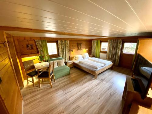 a bedroom with a bed and a table in a room at Lechnerhof Hotel-Garni in Achenkirch