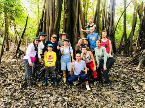 a group of people posing for a picture in the woods at Eco Hotel Aldea -AMAZONAS in Puerto Nariño