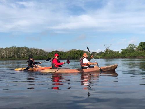 a group of people in kayaks on the water at Eco Hotel Aldea -AMAZONAS in Puerto Nariño