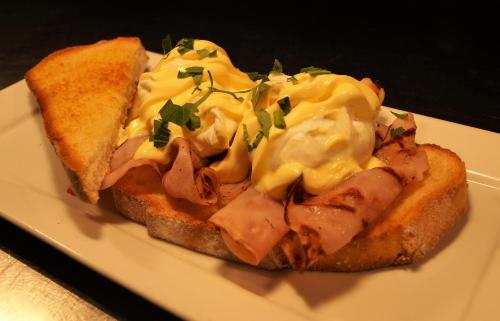 a sandwich with meat and cheese on a plate at Magdala Motor Lodge & Lakeside Restaurant in Stawell