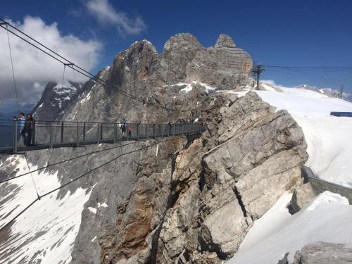 a suspension bridge on top of a snowy mountain at Frühstückspension Gsenger in Ramsau am Dachstein
