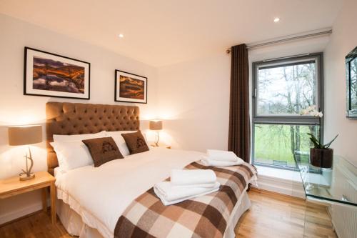 a bedroom with two beds and a window at Glenwood Apartment at The Highland Club in Fort Augustus