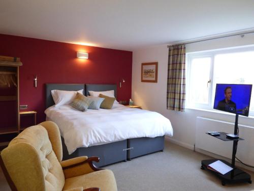 a bedroom with a large bed and a window at Highfield House, Parracombe, Modern B&B in Parracombe