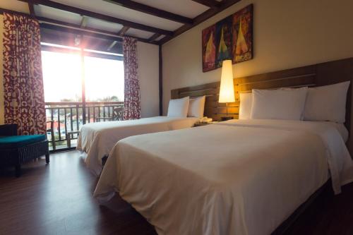 a hotel room with two beds and a balcony at Royal Decameron Punta Centinela - All Inclusive in Ballenita