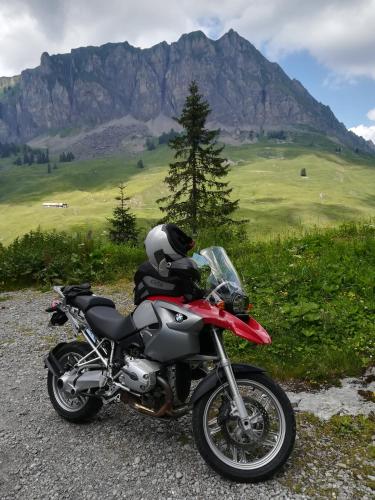 a red motorcycle parked on the side of a mountain at Hotel Rhodannenberg AG in Glarus