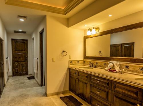 a bathroom with a sink and a large mirror at Cabo Hacienda with Private Pool and Rooftop Terrace! in Cabo San Lucas
