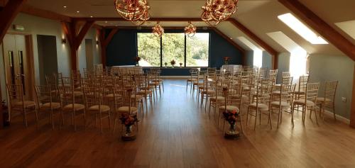 a room with a bunch of chairs in a hall at LLety Cynin in Llangynin