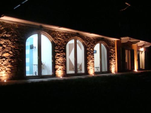 a building with three windows with lights on it at B&B Lago Maggiore in Cannobio