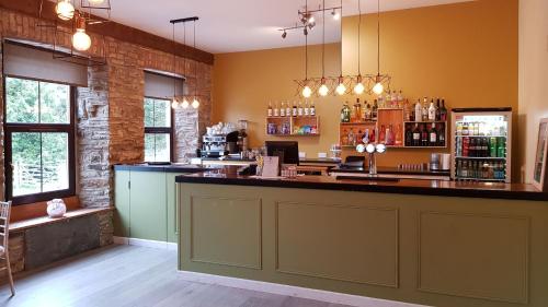 a bar in a restaurant with a counter top at LLety Cynin in Llangynin