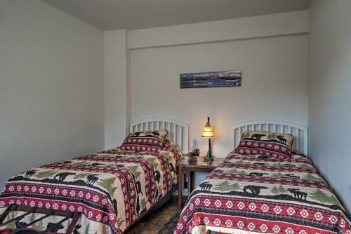 two beds sitting next to each other in a room at Homer Hideaway on Fritz Creekside - Pets Welcome in Homer