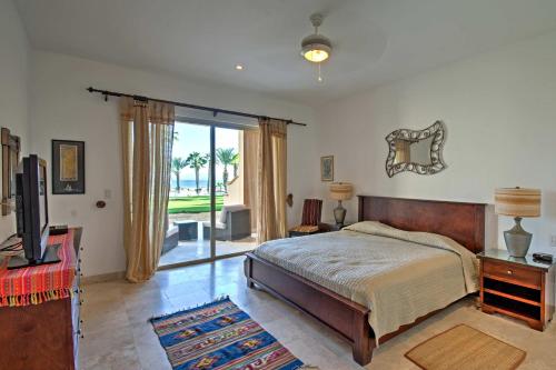 a bedroom with a bed and a tv and a window at Paraiso del Mar Resort Condo Water Taxi to La Paz in La Paz