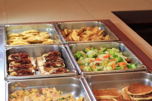 a bunch of trays filled with different types of food at Hotel Villa Mercedes Palenque in Palenque