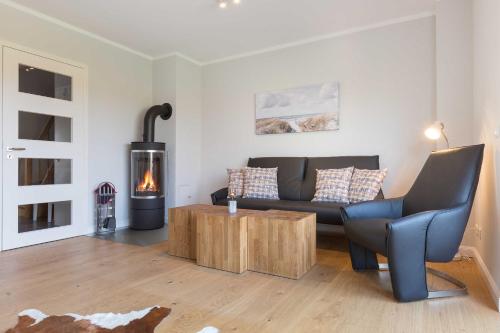 a living room with a couch and a fire place at Fehmarn in List
