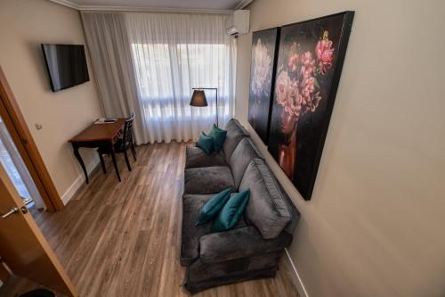 a living room with a couch and a table at Hotel Castilla Vieja in Palencia