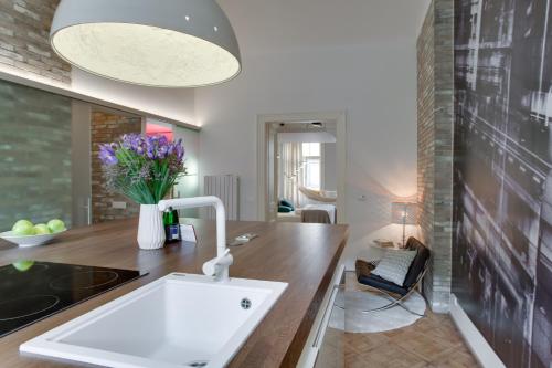 a kitchen with a sink and a counter at BRIGHT Prague Na Poříčí in Prague