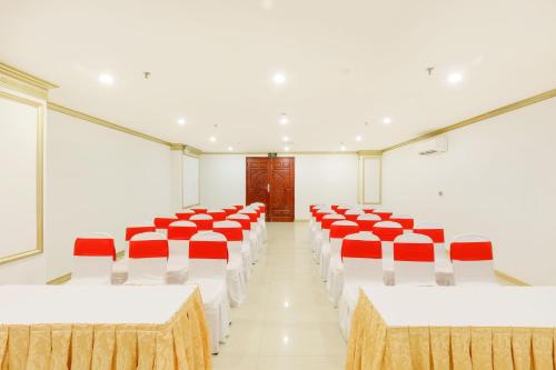 a room with red and white tables and chairs at Paris Luxury Hotel & Apartment Nha Trang in Nha Trang