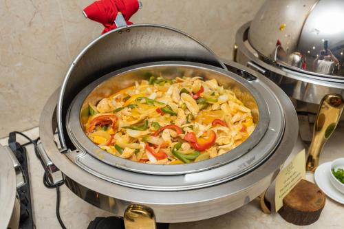 a pot of food sitting on top of a stove at Paris Luxury Hotel & Apartment Nha Trang in Nha Trang
