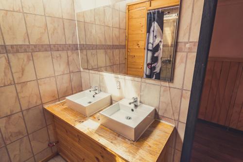 a bathroom with two sinks and a mirror at Goiien House in Torres del Paine