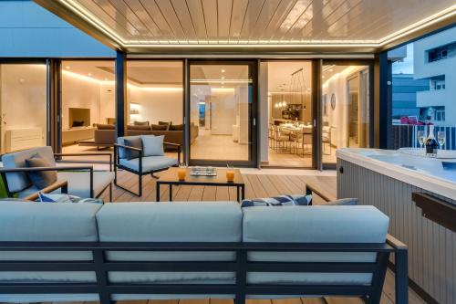 a living room with a couch on a balcony at Shell Luxury Residences with Pool and Whirlpool in Zadar