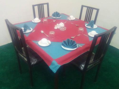 a table with a red and blue table cloth at Eden Lake View Hotel in Baltit
