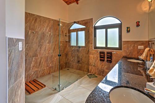 a bathroom with a shower with a glass door at Stunning Casa de la Roca House with Infinity Pool! in Ojochal