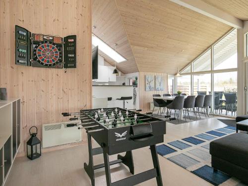 d'un salon avec un jeu de fléchettes et un baby-foot dans l'établissement 8 person holiday home in Idestrup, à Bøtø By