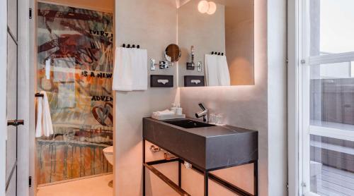 a bathroom with a black sink next to a window at Radisson Blu Seaside Hotel, Helsinki in Helsinki