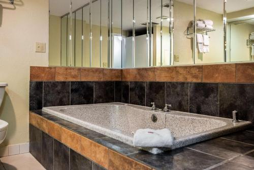 a large bath tub in a bathroom with a mirror at Motel 6-Philadelphia, PA - Northeast in Philadelphia