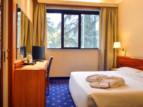 Posteľ alebo postele v izbe v ubytovaní Mercure Reggio Emilia Centro Astoria