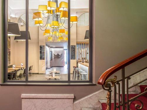 a lobby with a large mirror and a staircase at ibis Lyon Centre Perrache in Lyon